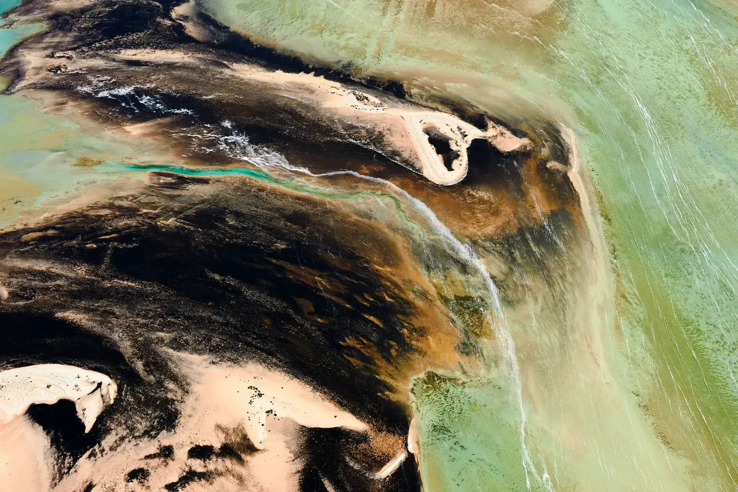 Contentment aerial art, Shark Bay, WA. Painterly confluence of pale aqua water and dark tidal flats.