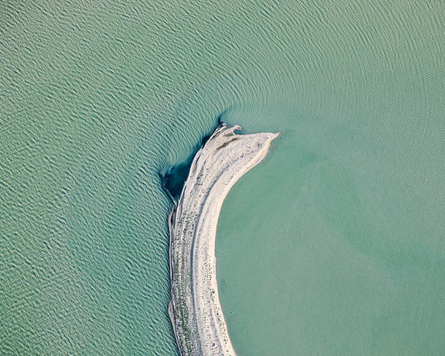 Tail aerial minimalist photo, Kati Thanda-Lake Eyre, South Australia. Pale crescent of land meets aqua water.